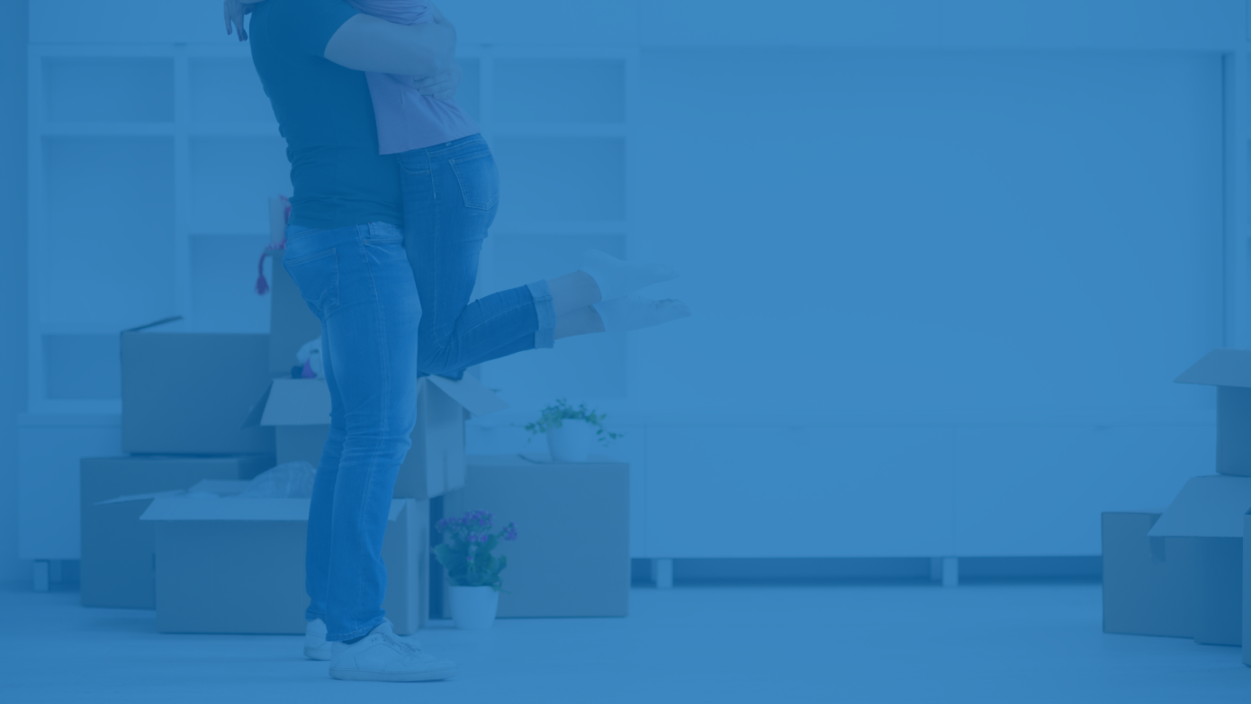 A couple embracing in their new home, celebrating a fresh start and improved financial stability