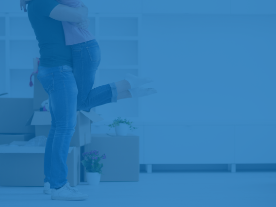 A couple embracing in their new home, celebrating a fresh start and improved financial stability